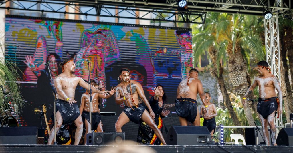 Men and women in traditional Aboriginal paint dancing on stage - events in Perth